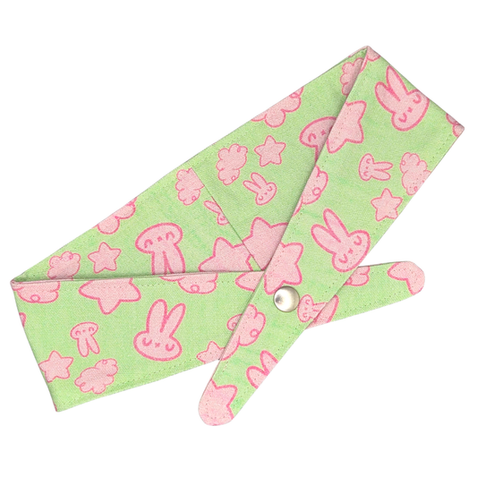 Fabric bandana with snap for dogs with pinkish cartoon characters on light green background